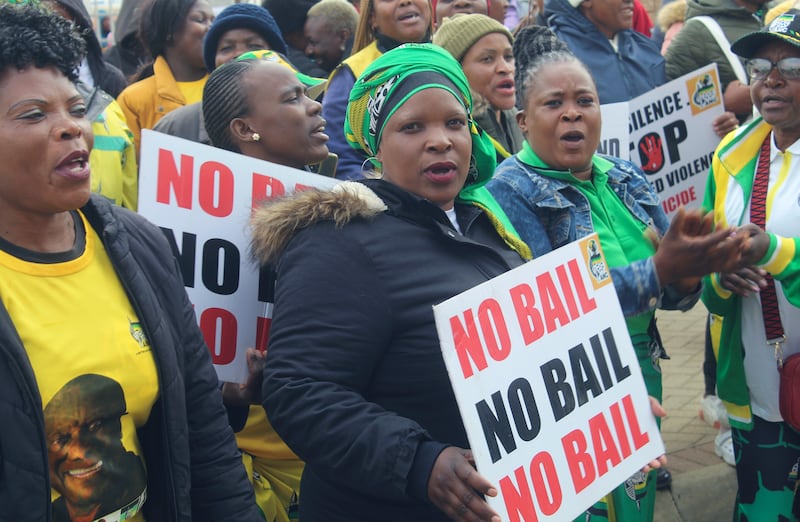 Protesters demonstrate outside the court in Polokwane, South Africa (AP)