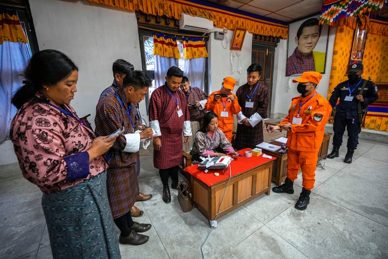 Polling officials unseal an electronic voting machine to count votes after the general election in Bhutan (Anupam Nath/AP)