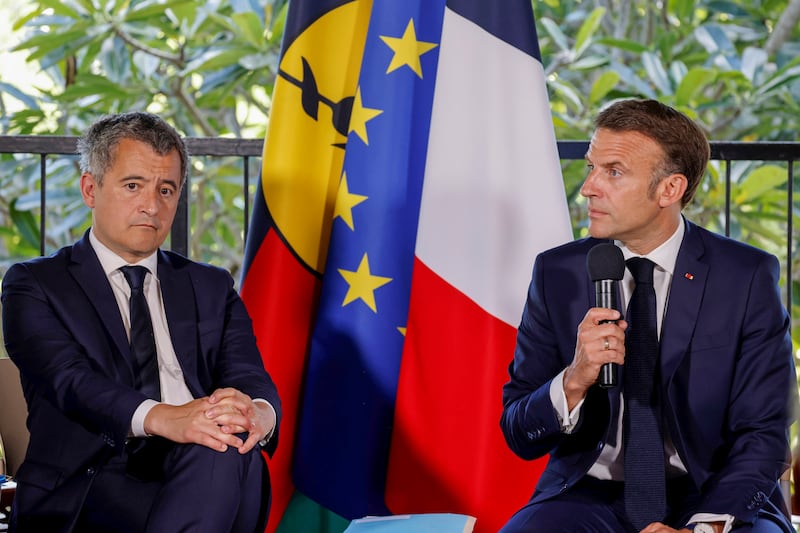 Mr Macron with France’s minister for interior and overseas Gerald Darmanin, left, during his visit (Ludovic Marin/Pool Photo via AP)