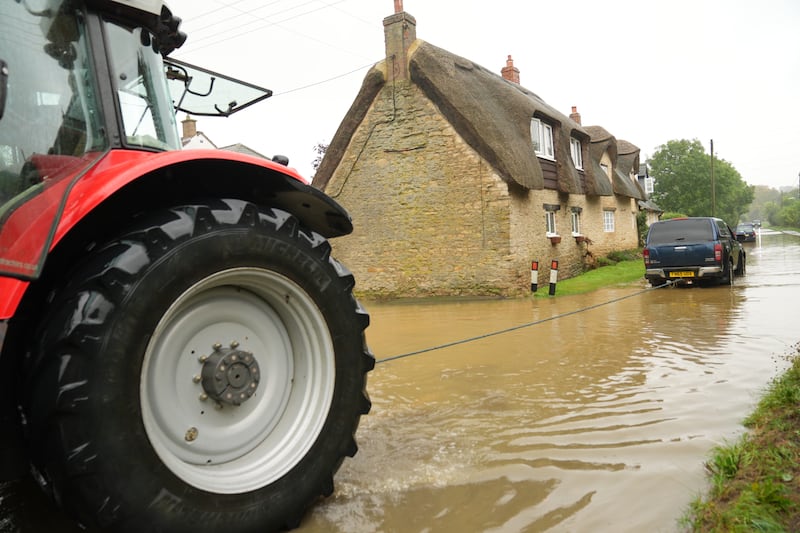 A tractor was used to rescue a vehicle stuck in flood water in Grendon, Northamptonshire