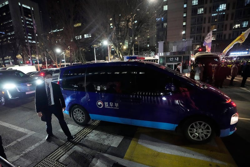 A vehicle carrying impeached South Korean President Yoon Suk Yeol leaves the Seoul Western District Court in Seoul, South Korea, on Saturday (Ahn Young-joon/AP)