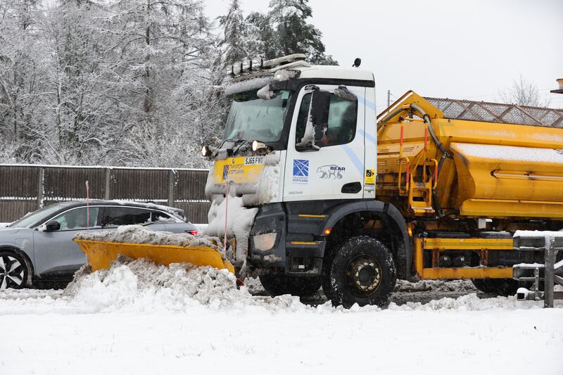 A snow plough and gritter clears snow on the M80 near Castlecary