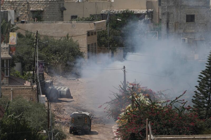 Smoke rises after an explosion during an Israeli military operation in the West Bank Jenin refugee camp on Saturday (Majdi Mohammed/AP)