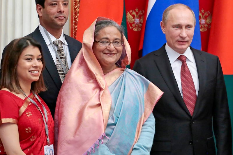 Sheikh Hasina, her niece Tulip Siddiq, and Russian President Vladimir Putin, pictured in 2013 (AP)