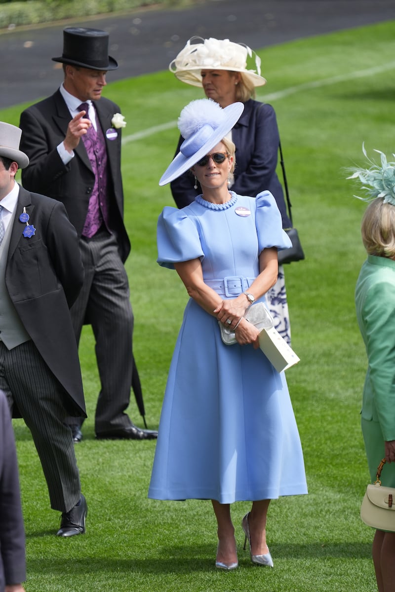 Olympian and daughter of Princess Anne, Zara Tindall sports powder blue puffed sleeve dress and flat rimmed hat