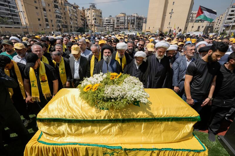 People pray over the coffin of senior commander Taleb Sami Abdullah, known within Hezbollah as Hajj Abu Taleb, who was killed on Tuesday by an Israeli strike in south Lebanon (Bilal Hussein/AP)