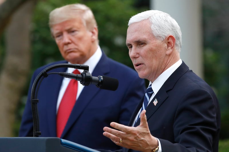 Then-president Donald Trump listens as then-vice president Mike Pence speaks during a briefing at the White House in 2020 (Patrick Semansky/AP)