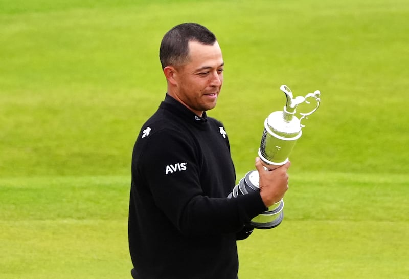 Xander Schauffele celebrates with the Claret Jug after winning The 152nd Open at Royal Troon