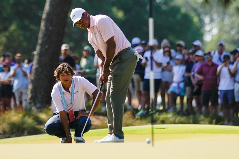Tiger Woods putts as his son Charlie watches on the seventh hole during a practice round for the US Open (George Walker IV/AP)