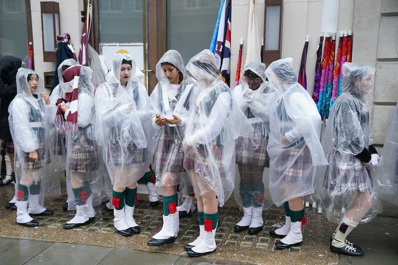 Rain falls as marching band members from Riverview High School in Florida prepare to take part in the New Year’s Day Parade in central London