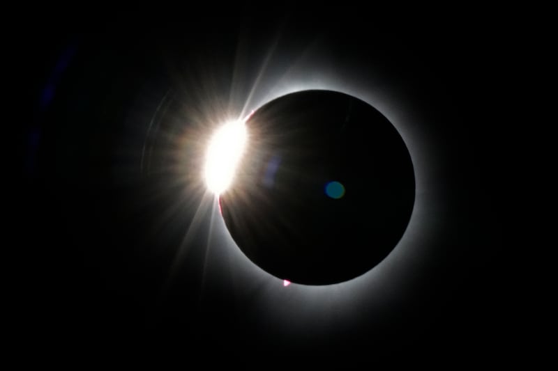 The moon covers most of the sun as seen from the summit of Saddleback Mountain in Maine (Robert F Bukaty/AP)