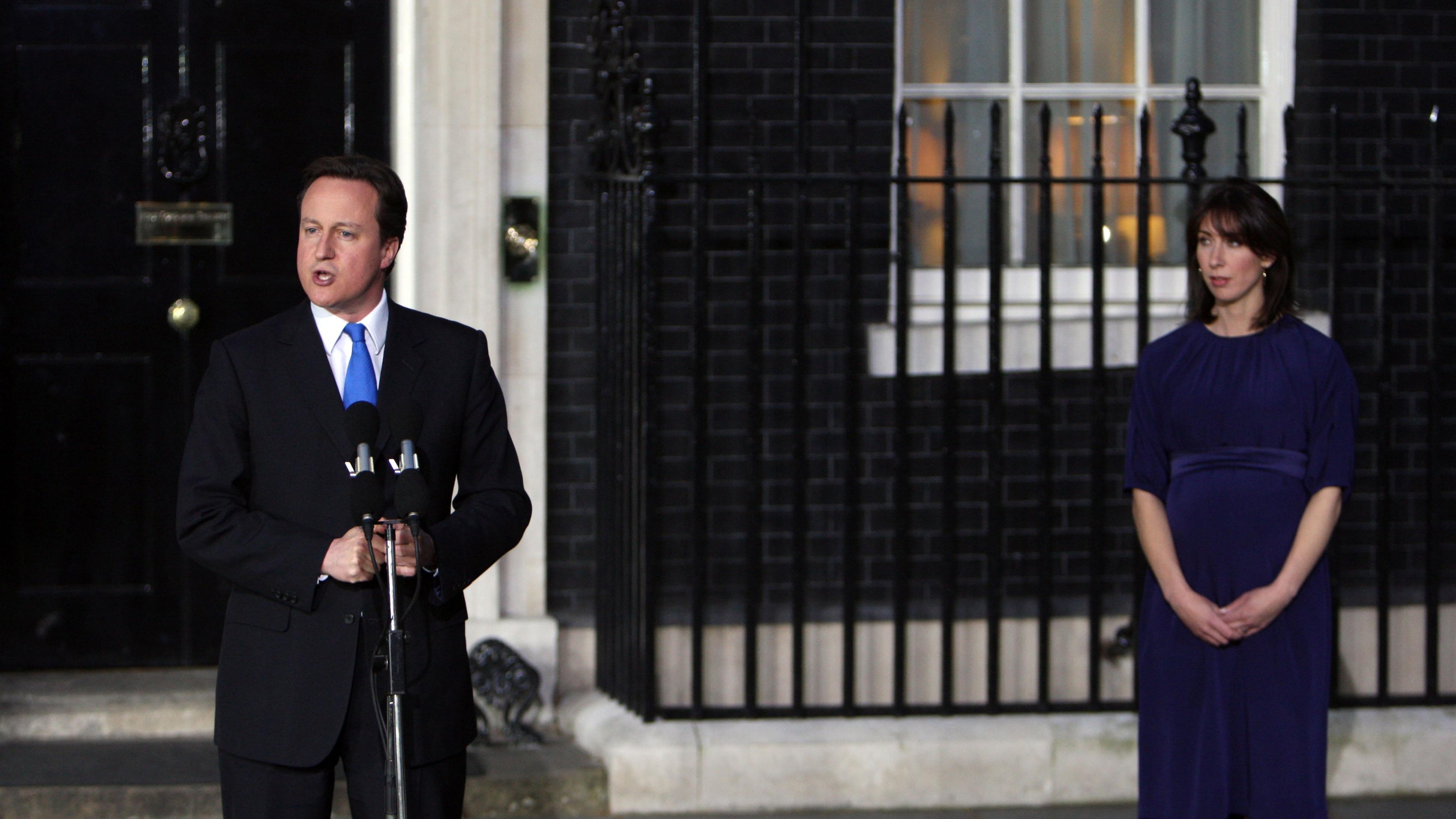 David Cameron, watched by his wife Samantha, addresses the nation from the steps of No 10 for the first time as prime minister