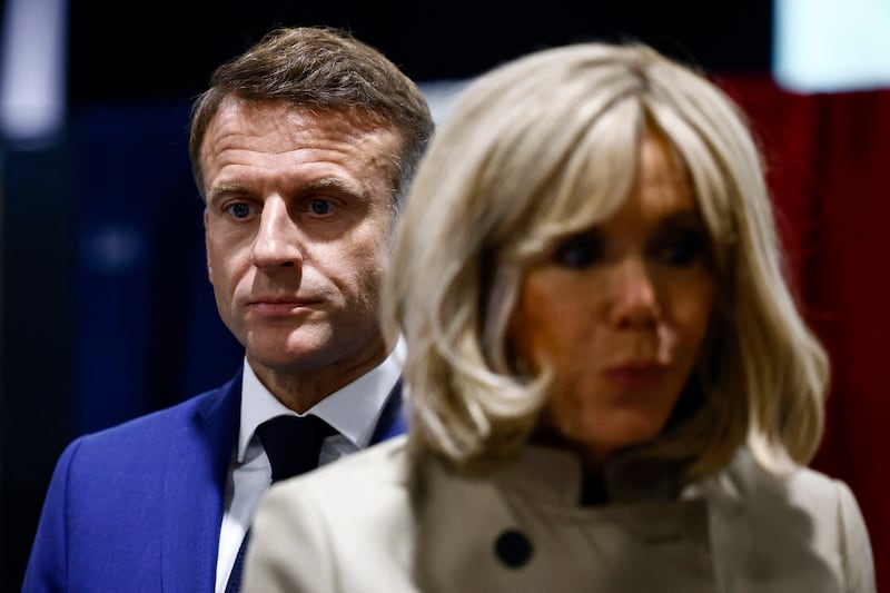 French President Emmanuel Macron and his wife Brigitte Macron after voting in Le Touquet-Paris-Plage, northern France (Yara Nardi, Pool via AP)