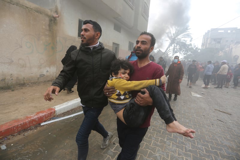 Palestinians evacuate survivors of an Israeli strike in Rafah, Gaza Strip (Hatem Ali/AP)