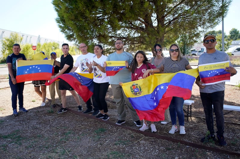 Supporters of Edmundo Gonzalez wait for his arrival outside the Torrejon Air Base in Madrid (Andrea Comas/AP)