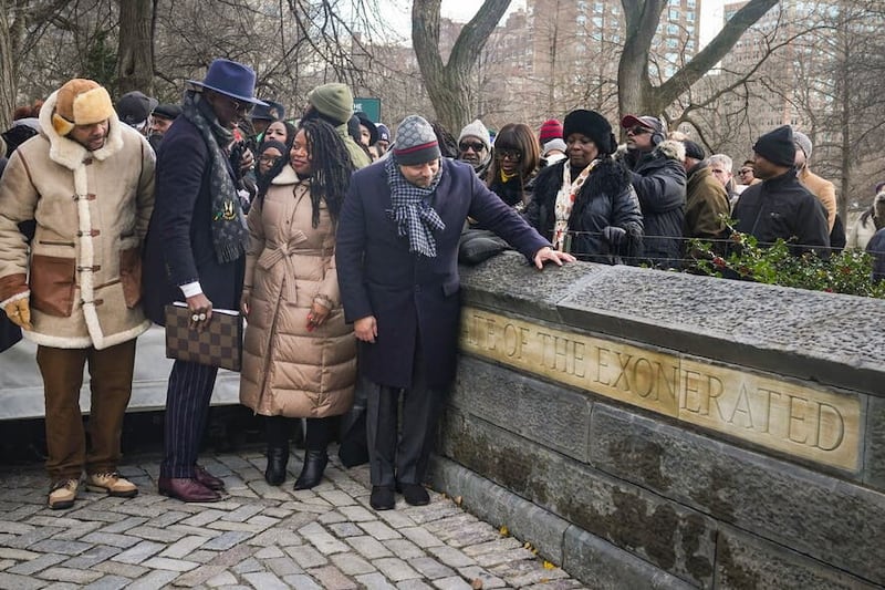 Kevin Richardson, far left, Yusef Salaam, second from left, and Raymond Santana Jr., far right foreground, three of five men exonerated after being wrongfully convicted as teenagers for the 1989 rape of a jogger in Central Park, along with Cicely Harris, second from right, chair of Harlem’s Community Board 10, unveil the “The Gate of the Exonerated” at the northeast gateway of Central Park in New York (Bebeto Matthews/AP/PA)