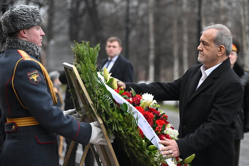 Iranian President Masoud Pezeshkian attends a laying of the wreath ceremony at the Unknown Soldier near the Kremlin Wall in Moscow (Pool via AP)