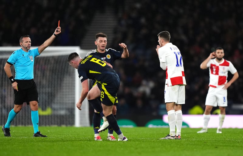 Croatia’s Petar Sucic, second right, is sent off