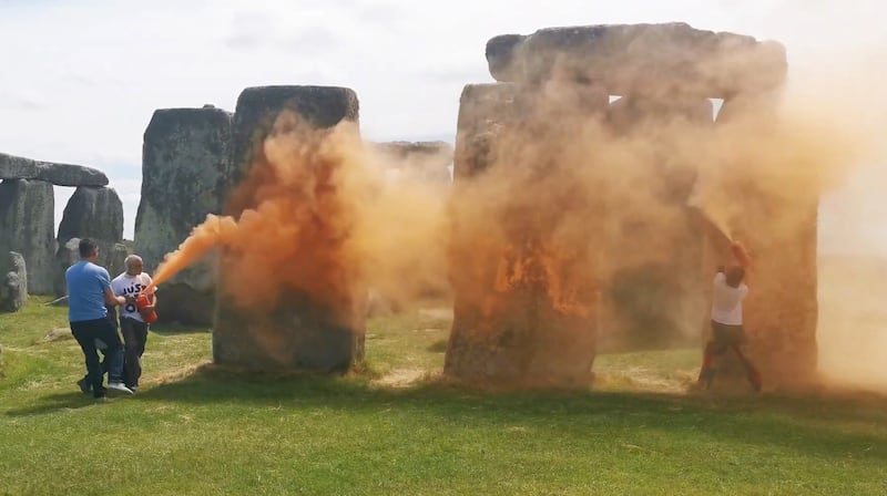 Just Stop Oil protesters spraying an orange substance on Stonehenge