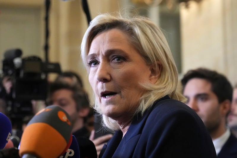 French far-right leader Marine Le Pen speaks to reporters at the National Assembly ahead of the vote (AP Photo/Michel Euler)