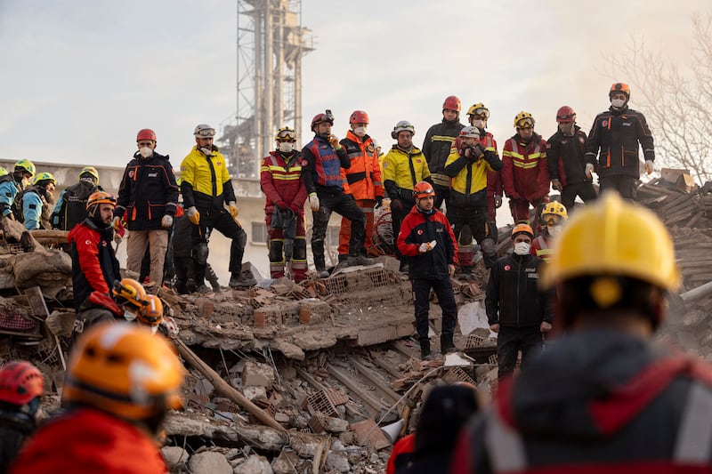 Emergency and rescue team members work in the aftermath of a building that collapsed in the city of Konya (Ugur Yildirim/Dia Photo via AP)