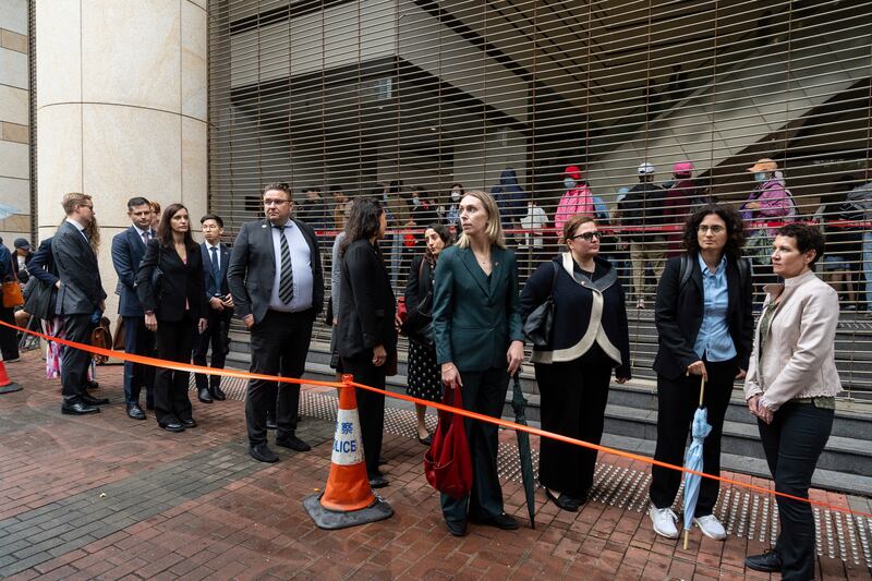 Representatives from different consulates waited in line outside the court (Chan Long Hei/AP)