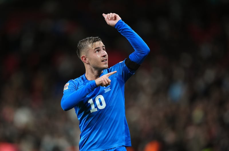 Dimitrios Pelkas points to his black armband in memory of George Baldock