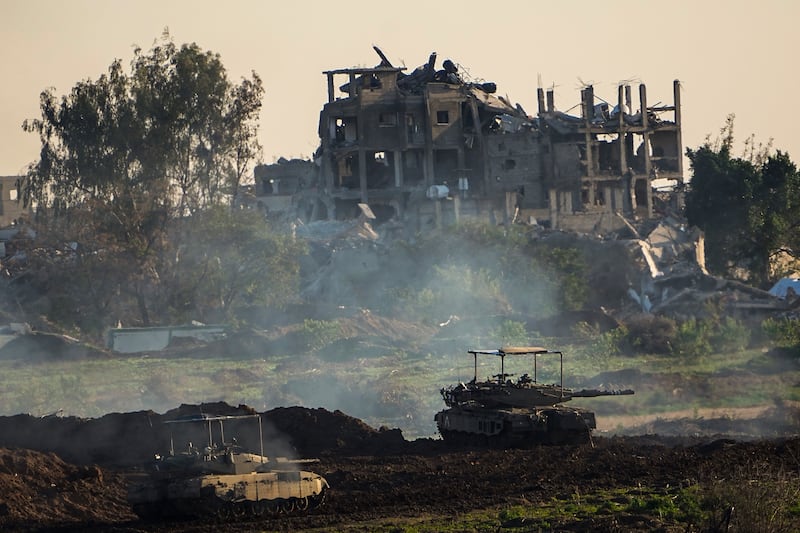 Israeli tanks next to a destroyed building during a ground operation in the northern Gaza Strip (Ariel Schalit/AP)