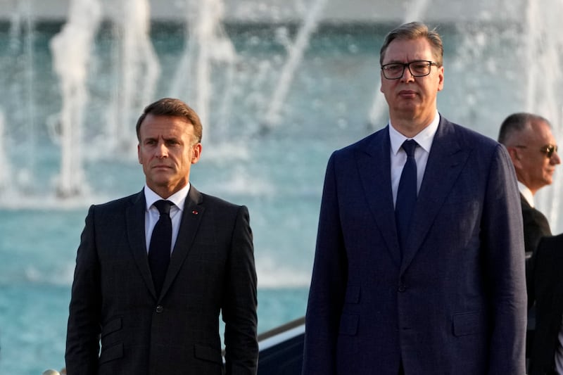 French President Emmanuel Macron, left, and Serbian President Aleksandar Vucic stand during a welcoming ceremony in Belgrade, Serbia (Darko Vojinovic/AP)