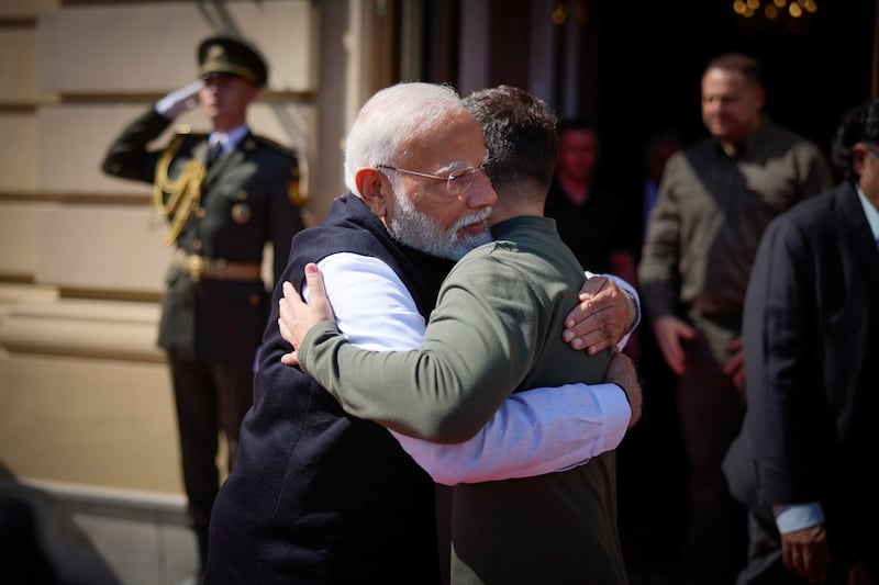 Narendra Modi and Volodymyr Zelensky embrace in Kyiv (Ukrainian Presidential Press Office/AP)