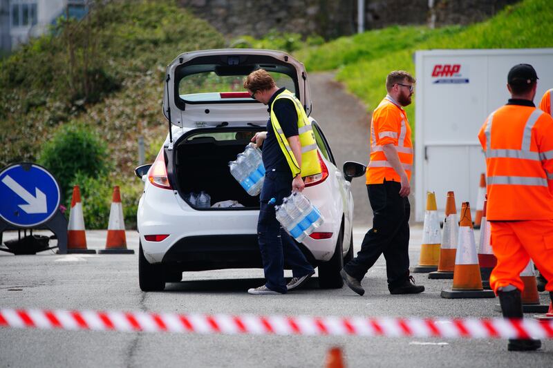 People collecting bottled water in Brixham, Devon