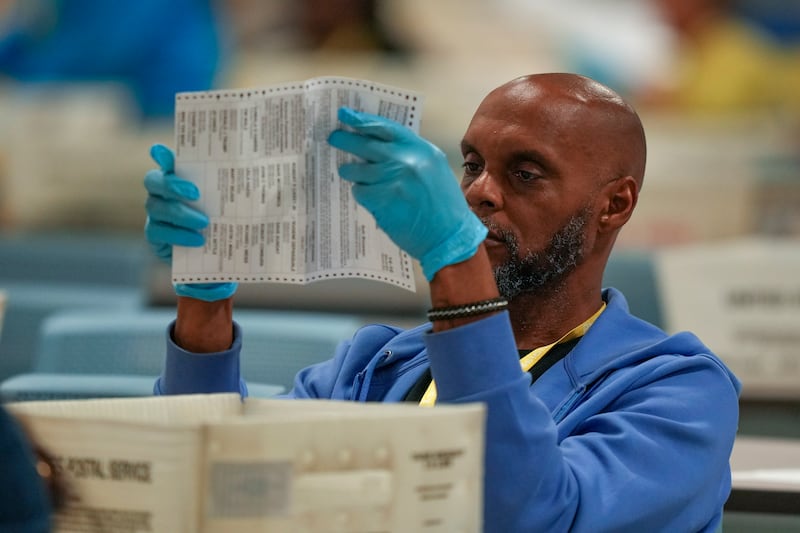 An election worker processing postal votes at the Philadelphia Election Warehouse (AP Photo/Matt Slocum)