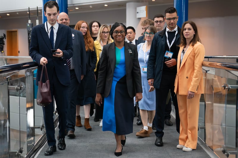 Tory leadership candidate Kemi Badenoch walks with her team through the Birmingham International Conference Centre