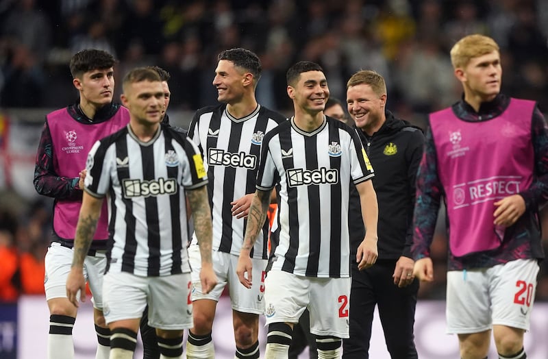 Newcastle boss Eddie Howe celebrates with his layers after a 4-1 Champions League victory over Paris St Germain at St James’ Park