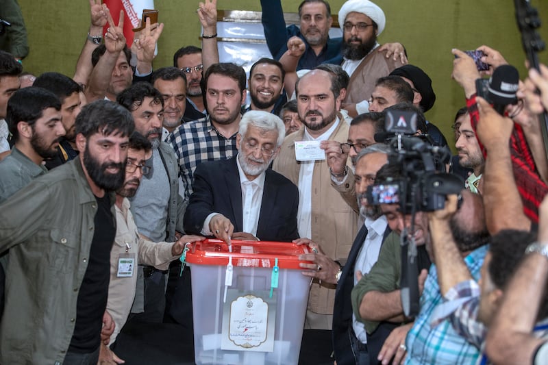 Candidate for the Iran’s presidential election Saeed Jalili, a hard-line former nuclear negotiator, casts his vote for the presidential run-off (AP Photo)