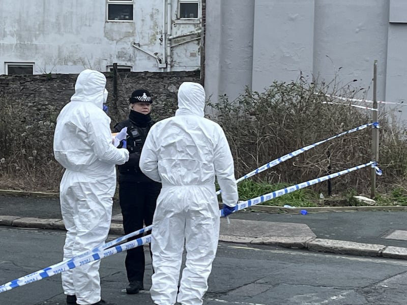 Forensic officers investigate at the scene in Plymouth, Devon