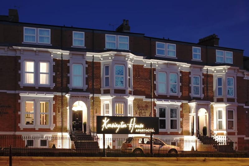 Wide exterior photo of Kensington House at dusk.