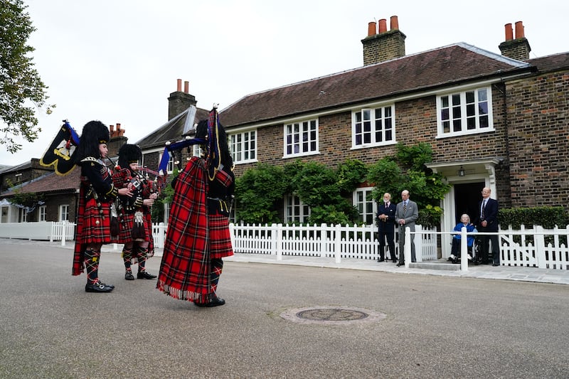 Prince Michael of Kent, the Duke of Kent, the Duchess of Kent and Lord Nicholas Windsor watch the three pipers outside Wren House