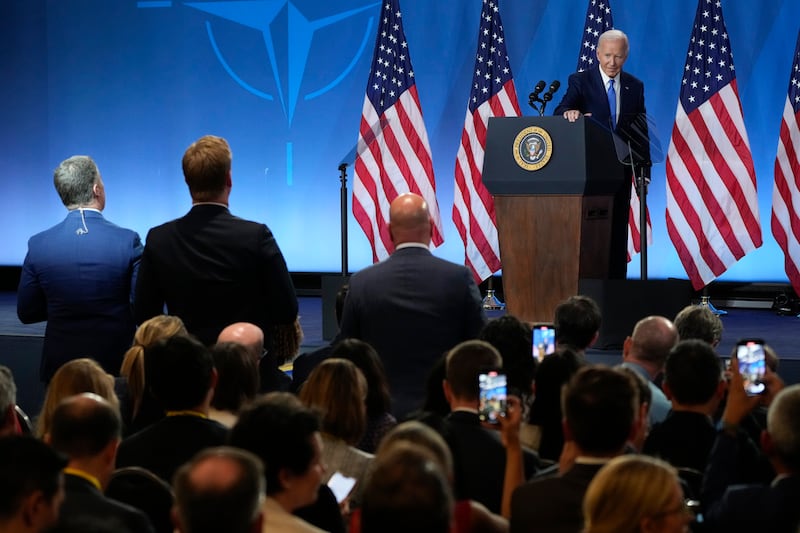 As reporters continue to ask questions, President Joe Biden walks from the podium after a news conference (Jacquelyn Martin/AP)