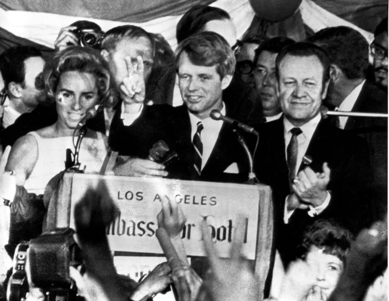 Senator Robert F Kennedy speaks to campaign workers at the Ambassador Hotel in Los Angeles in June 1968, watched by his wife Ethel, left, and California campaign manager Jesse Unruh, just before being was shot in an adjacent room (AP)