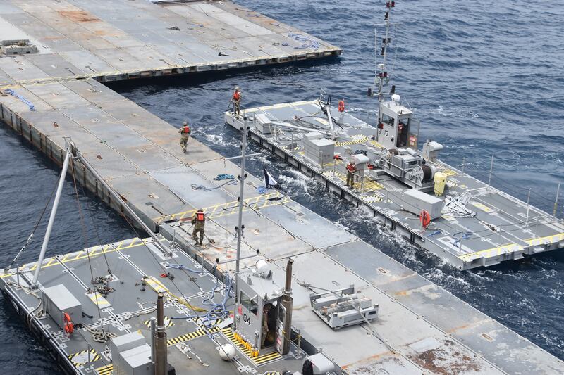 Soldiers assigned to the 7th Transportation Brigade (Expeditionary) and sailors attached to the MV Roy P Benavidez assemble the roll-on, roll-off distribution facility off the shore of Gaza in the Mediterranean Sea (US Army via AP)