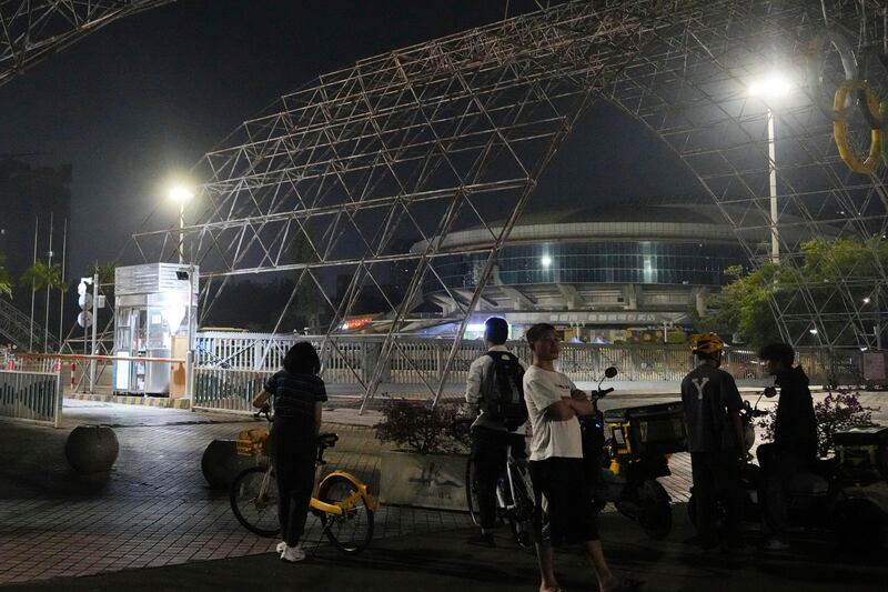 People gather near the sports centre after the incident (Kyodo News/AP)