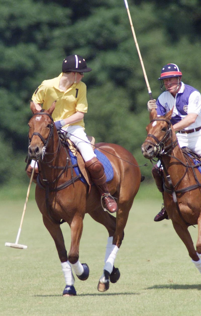 Prince Harry competes against his father the then-Prince of Wales on the polo field at Cirencester Park Polo Club in 2001