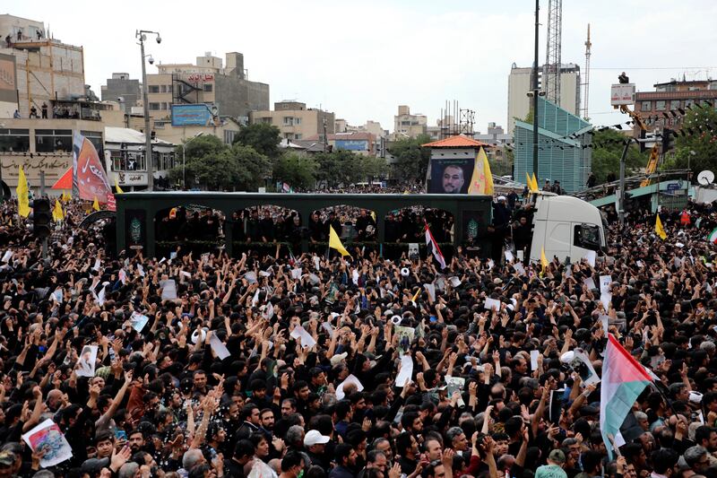 Mourners surround a truck carrying the flag-draped coffins of Ebrahim Raisi (Mohammad Hasan Salavati, Shahraranews via AP)