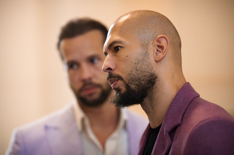 Andrew Tate, right, stands next to his brother Tristan, left, at the Court of Appeals building in Bucharest, Romania, last week (Vadim Ghirda/AP)