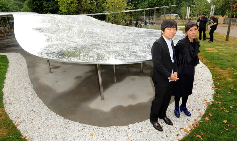 The Serpentine Gallery Pavilion designers Ryue Nishizawa and Kazuyo Sejima stand beside their creation in west London