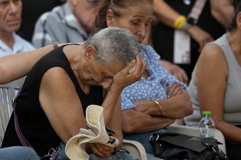 Tami Metzger mourns during the funeral of her husband Yoram Metzger at a cemetery of the kibbutz Nir Oz, southern Israel (Tsafrir Abayov/AP)