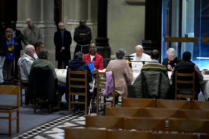 Pope Francis reads a message during a breakfast with people who are experiencing homelessness (Andrew Medichini/AP)