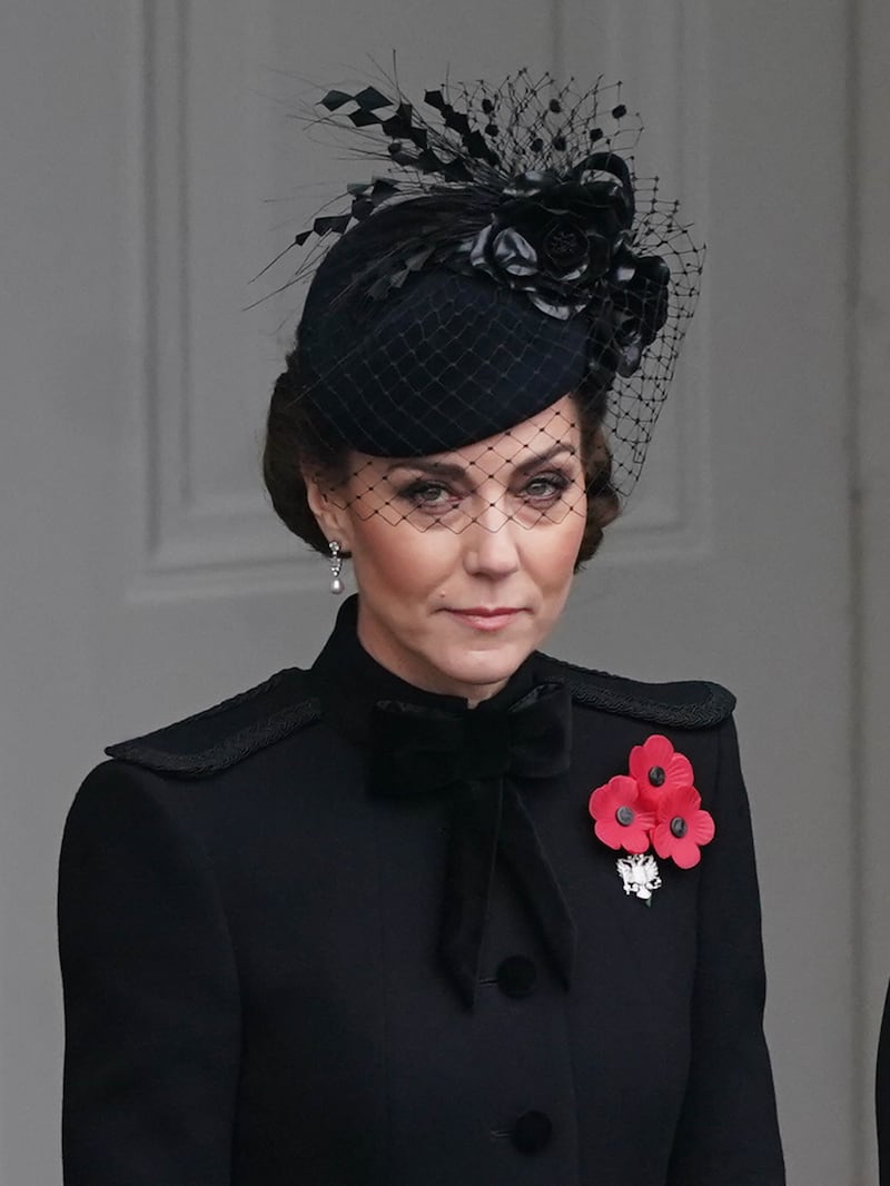 The Princess of Wales wore a netted hat, with her hair in a twisted chignon, and a military-style coat