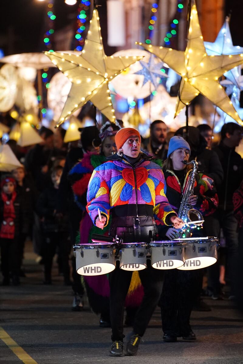 People take part in a lantern parade in Liverpool to mark the reopening of Spellow Community Hub